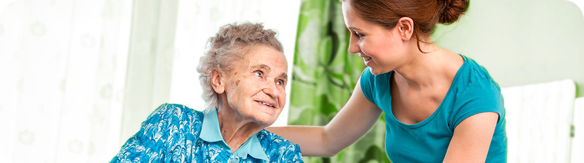 Image of a person helping an elderly person.